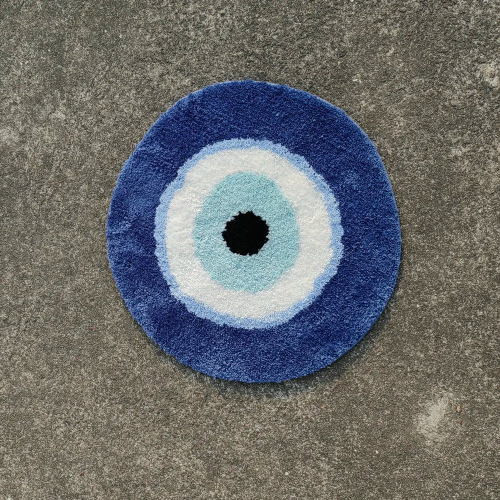 Round blue doormat with a central black circle on a concrete floor boho home decor, evil eye rug, tufted bathroom rug, fluffy circle rug, plush floor mat, round bath mat, anti-slip mat, dorm decor, Halloween decor, housewarming gift, bathroom accessories, bedroom rug, living room carpet