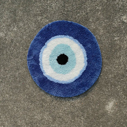 Round blue doormat with a central black circle on a concrete floor boho home decor, evil eye rug, tufted bathroom rug, fluffy circle rug, plush floor mat, round bath mat, anti-slip mat, dorm decor, Halloween decor, housewarming gift, bathroom accessories, bedroom rug, living room carpet