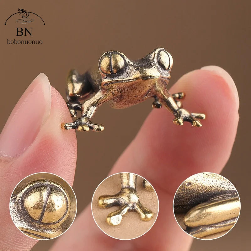 Bronze frog figurine held between fingers with close-up insets showing detailed textures.