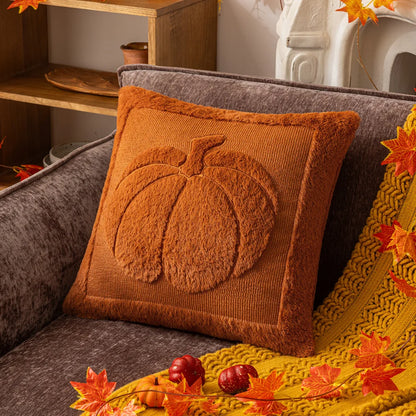 Decorative pillow with a pumpkin design on a couch with autumn-themed decor. Halloween pumpkin plush pillow cover for sofa and bed decor.