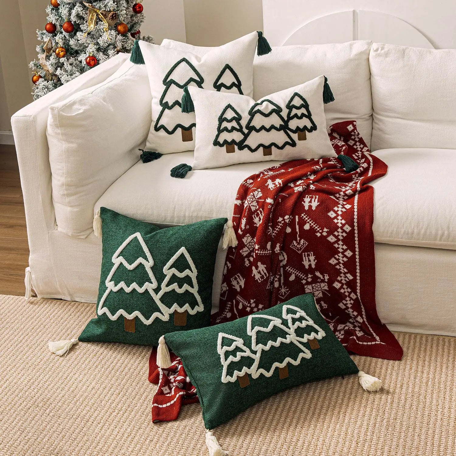 Decorative pillows and blanket with Christmas tree patterns on a white couch. tufted Christmas pillow cover with tassels, decorative festive cushion case for sofa or bed in 12x20 or 18x18 inches.