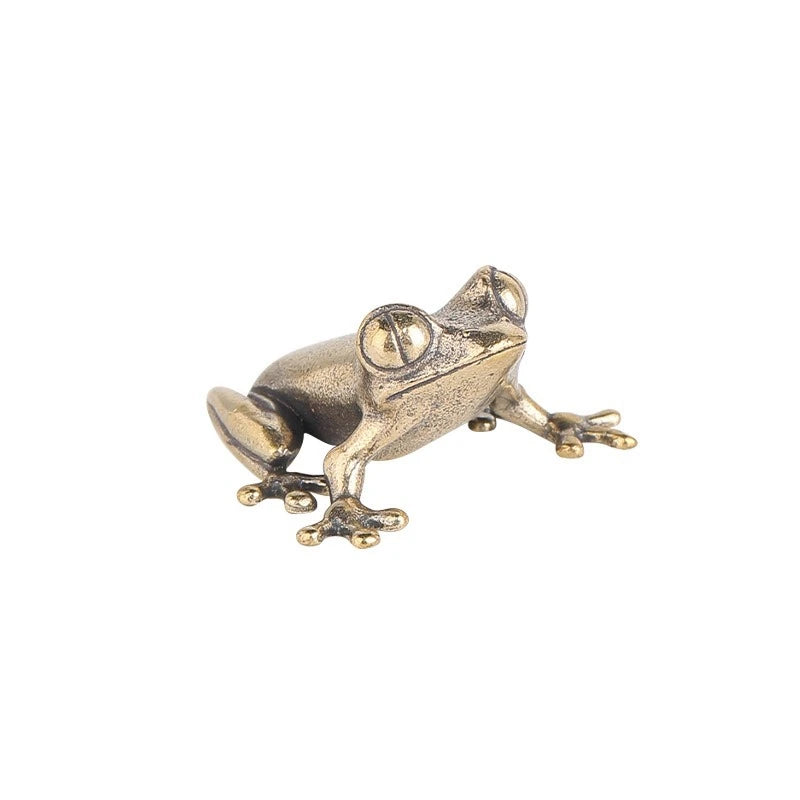 Bronze frog sculpture on a white background
