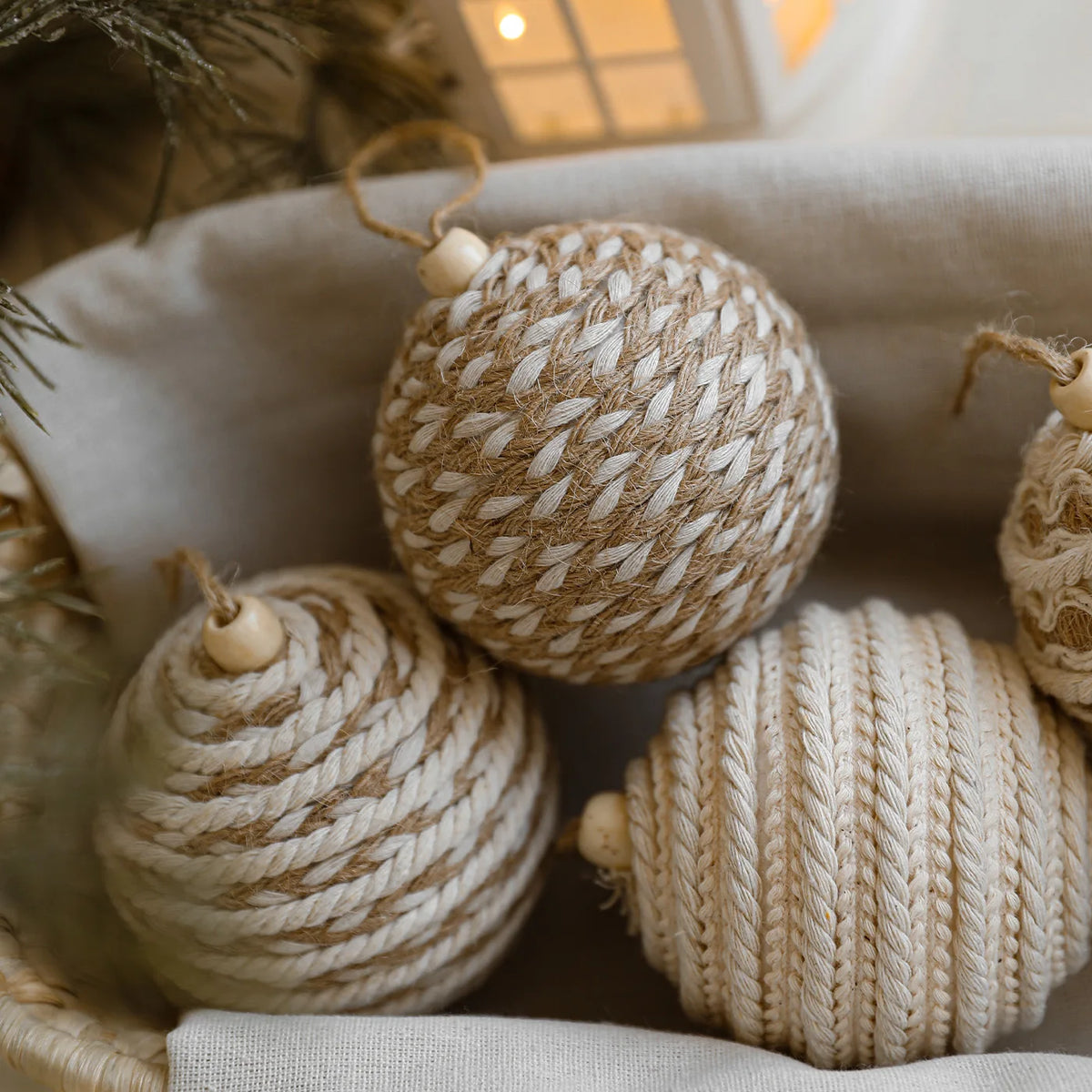 Textured beige and brown spherical ornaments in a basket with a soft focus background.