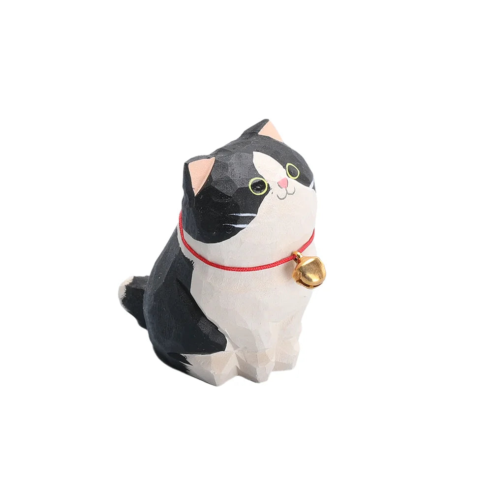 Cat-shaped figurine with a red collar and gold bell on a white background