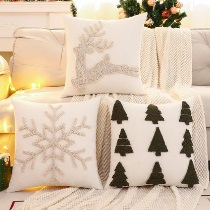 Decorative pillows with reindeer, snowflake, and tree patterns on a couch. Christmas embroidered pillow cover with tufted snowflake and reindeer design in 18x18 inches, festive canvas cushion case for sofa or bed