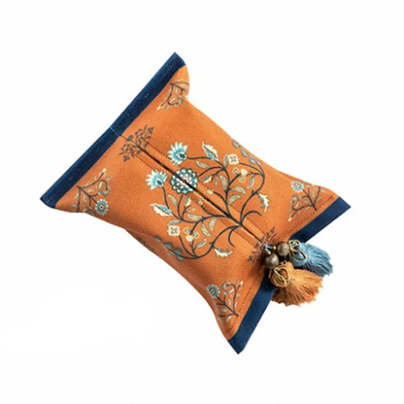 Decorative orange pillow with floral patterns and tassels on a white background boho home decor, reusable tissue bag, cotton tassel tissue holder, plush tissue organizer, bathroom tissue box cover, car tissue case, American style tissue pouch, soft fabric tissue holder, decorative tissue box, housewarming gift, eco-friendly storage