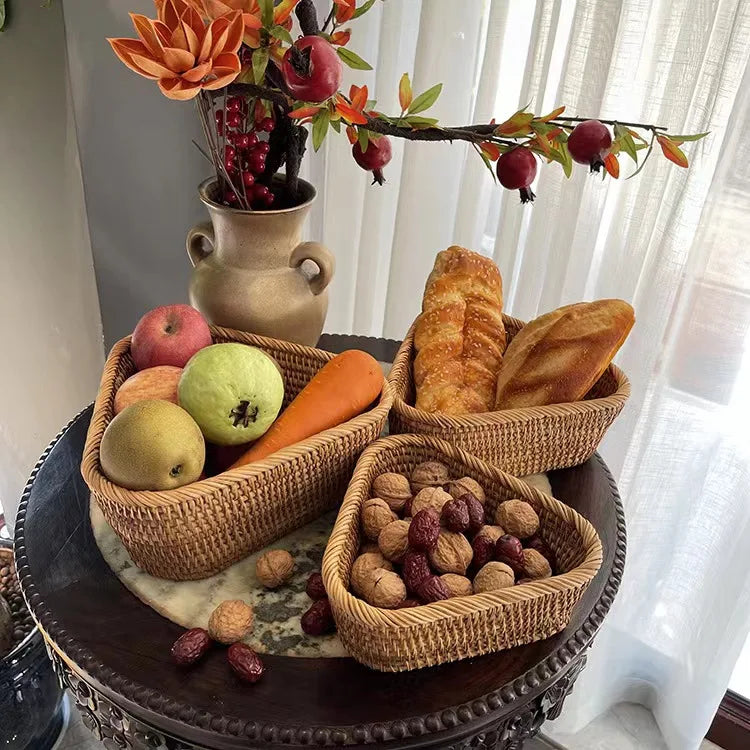 Three woven baskets with fruits, bread, and nuts on a decorative table. boho home decor, rattan basket, handwoven wicker basket, fruit storage box, bread basket, picnic basket, natural storage bin, tea storage box, rustic home organization, farmhouse decor, housewarming gift, boho storage basket