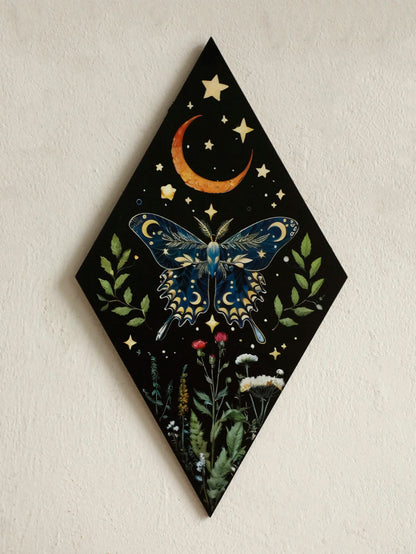 Decorative wall art with a butterfly, moon, and stars on a black diamond-shaped background. Rustic colorful wood wall art panel with moon, stars, and butterfly engraving, displayed above a sofa in a boho-styled living room