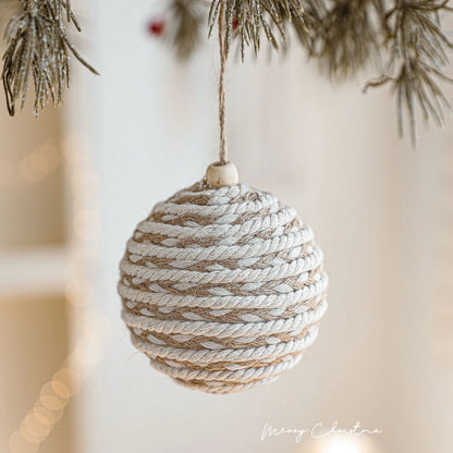 Textured Christmas ornament hanging on a tree branch with a blurred background