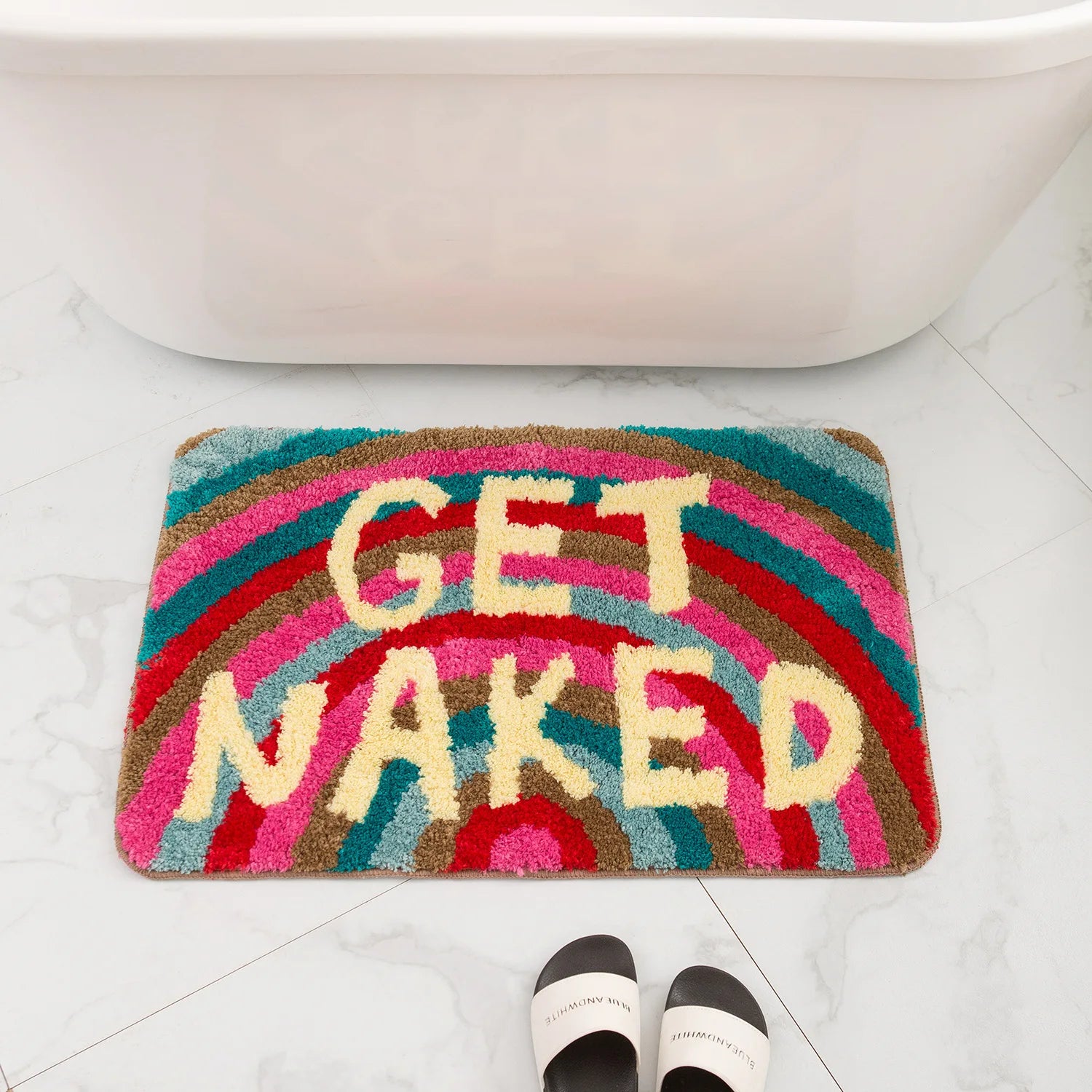 Colorful bath mat with 'GET NAKED' text on a bathroom floor. boho home decor, bathroom rug, tufted bath mat, Get Naked rug, colorful shower mat, apartment decor, dorm bathroom accessories, housewarming gift, microfiber bath mat, fun bathroom rug, American style bath mat