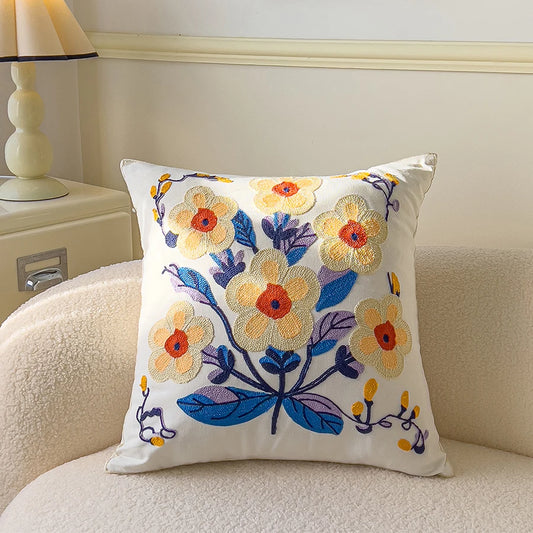 Decorative pillow with floral embroidery on a couch