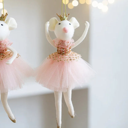 Two decorative mouse figurines in ballerina costumes with pink tutus and gold crowns on a light background.