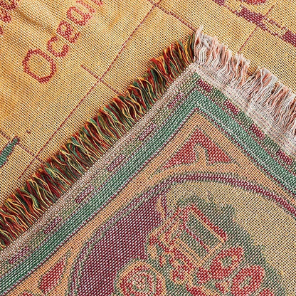 Close-up of a woven fabric with colorful patterns and fringes. Multi-purpose world map tapestry throw blanket for sofa or table