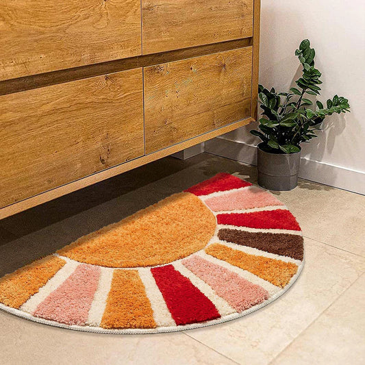 Colorful geometric-patterned rug on a tiled floor next to a wooden cabinet. boho home decor, sunflower door mat, half circle rug, plush entry mat, non-slip bath mat, boho floor mat, floral floor rug, bathroom rug, farmhouse decor, cozy home gift, housewarming gift, living room mat, pastel home accents, cute doormat