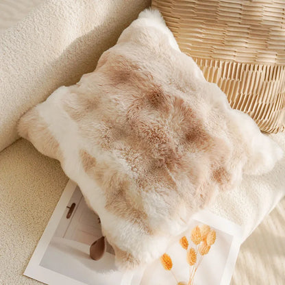 Fluffy pillow with a floral pattern on a soft surface