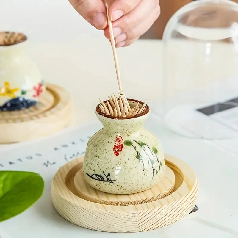 Ceramic toothpick holder with wooden lid on a white surface