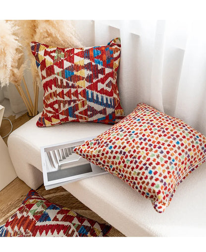 Colorful patterned cushions on a white sofa with a decorative plant in the background.Bohemian Aztec woven pillow cover, geometric jacquard cushion for sofa, bed, or living room decor in neutral cotton blend fabric.