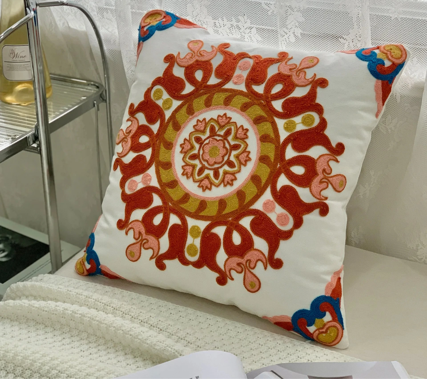 Decorative pillow with intricate patterns on a couch, floral embroidery on linen cotton cushion cover – boho home decor accent