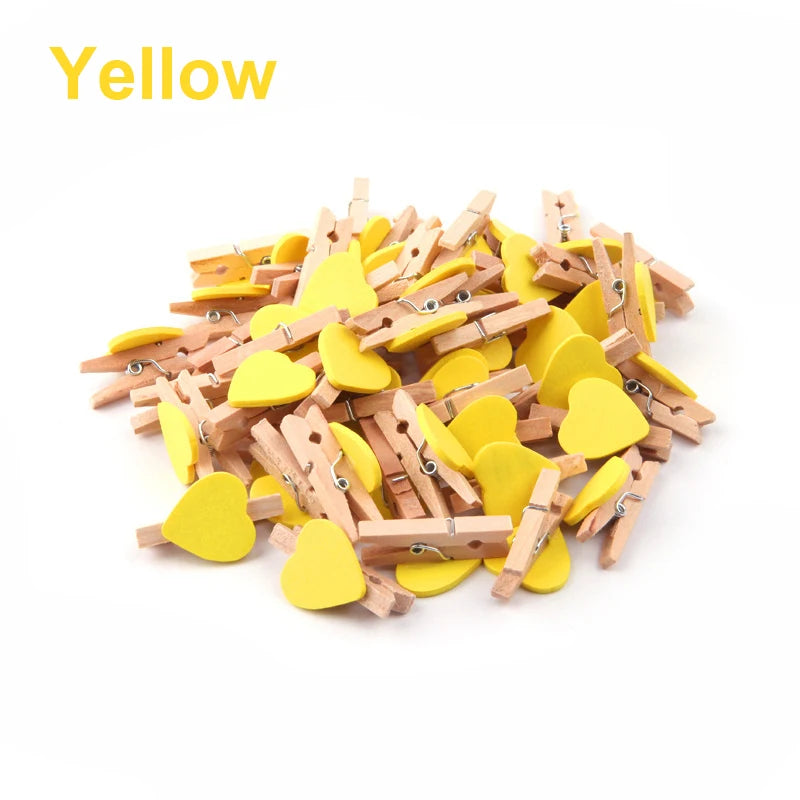 Yellow heart-shaped wooden clips on a white background