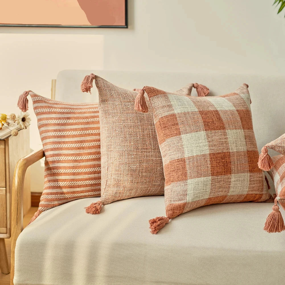 Orange linen tassels cushion cover styled on modern sofa, decorative boho throw pillow for living room, bed, or chair, perfect for cozy home vibes and housewarming gift ideas