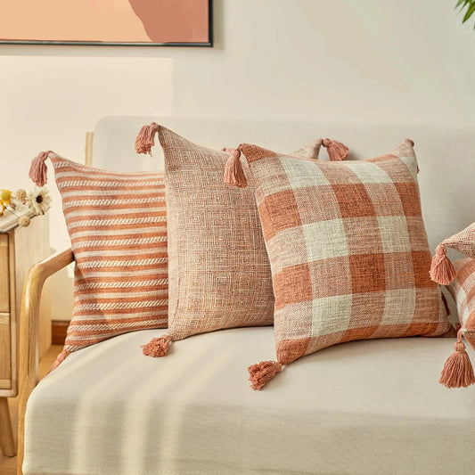 Orange linen tassels cushion cover styled on modern sofa, decorative boho throw pillow for living room, bed, or chair, perfect for cozy home vibes and housewarming gift ideas