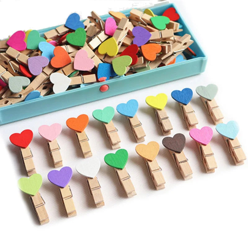 Colorful heart-shaped wooden clips on a white background