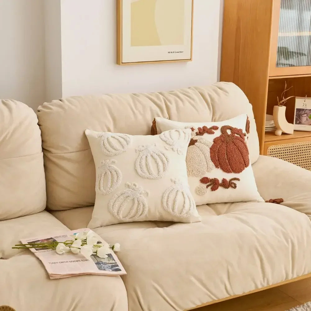 Beige sofa with decorative pillows and a magazine on a light-colored floor. Cartoon pumpkin cushion cover for kids’ room, fall and Halloween decorations