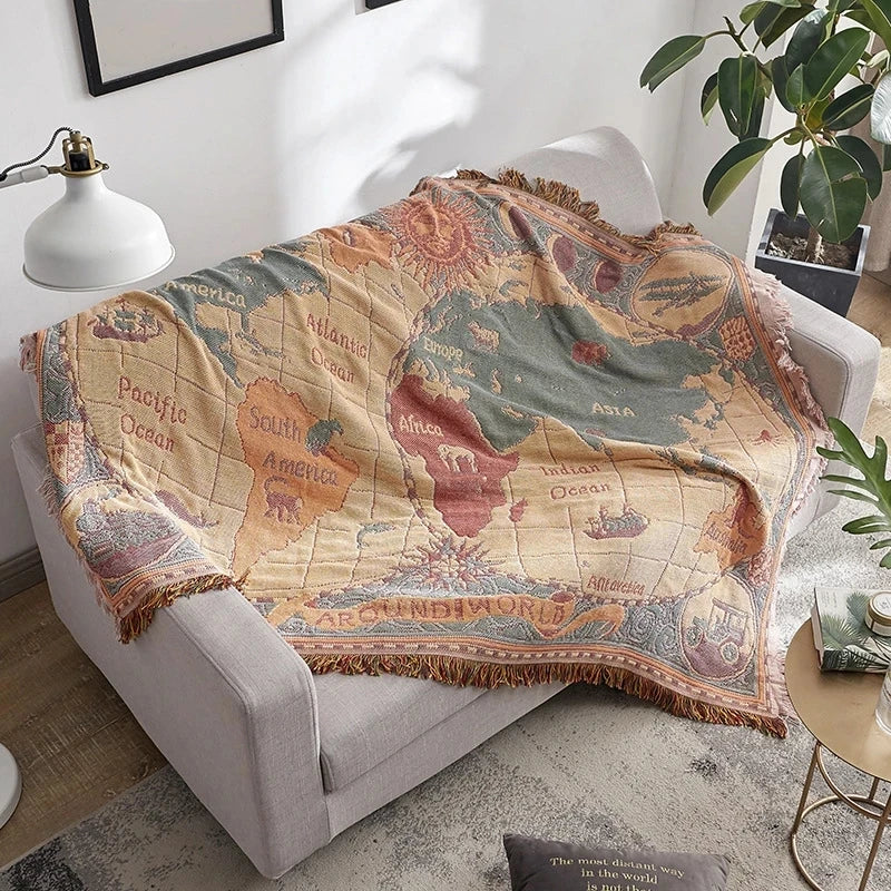 World map blanket draped over a sofa in a living room setting. Bohemian world map woven blanket cotton sofa throw home decor