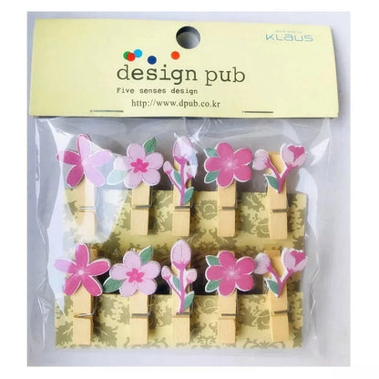 Set of wooden clothespins with floral designs in a package labeled 'design pub'.