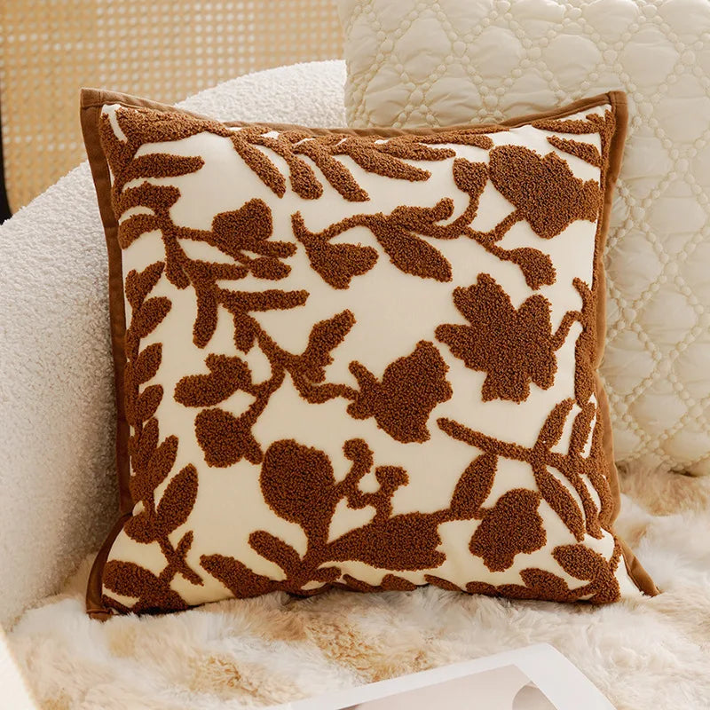 Decorative pillow with brown floral pattern on a beige background