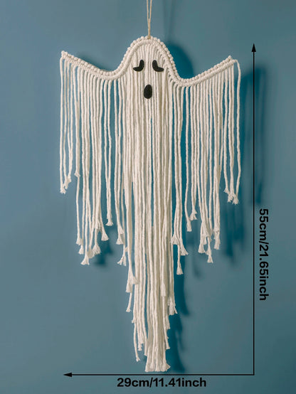 A white macrame ghost wall hanging with a black embroidered face, shown against a blue background with dimension lines indicating 55cm height and 29cm width from My Boho Home