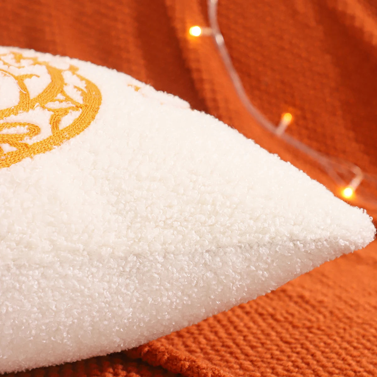 White rice cake with a yellow design on an orange background. fall boho pillow throw gift ideas
