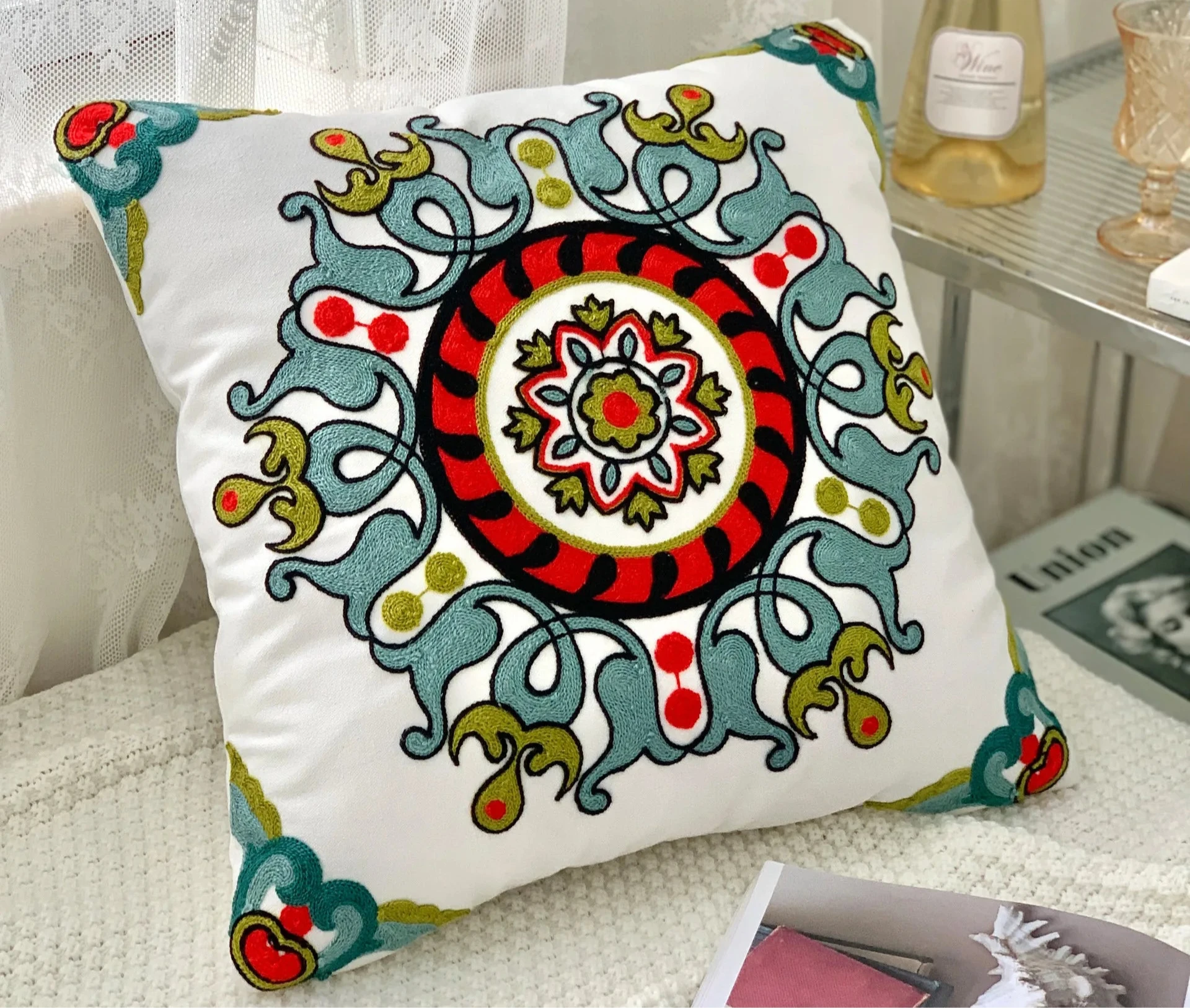 Decorative pillow with colorful patterns on a couch, floral embroidery on linen cotton cushion cover – boho home decor accent
