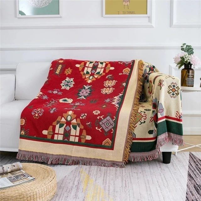 Decorative blanket with geometric patterns draped over a sofa in a living room. Mediterranean style woven cotton throw blanket boho home decor