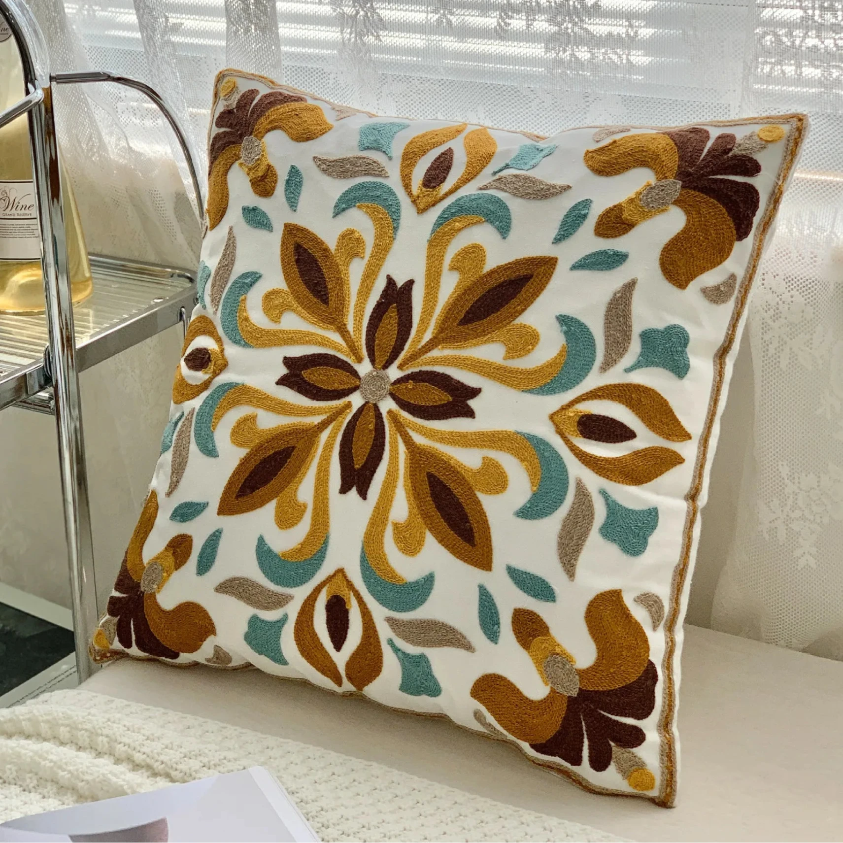 Decorative pillow with floral pattern on a couch, floral embroidery on linen cotton cushion cover – boho home decor accent