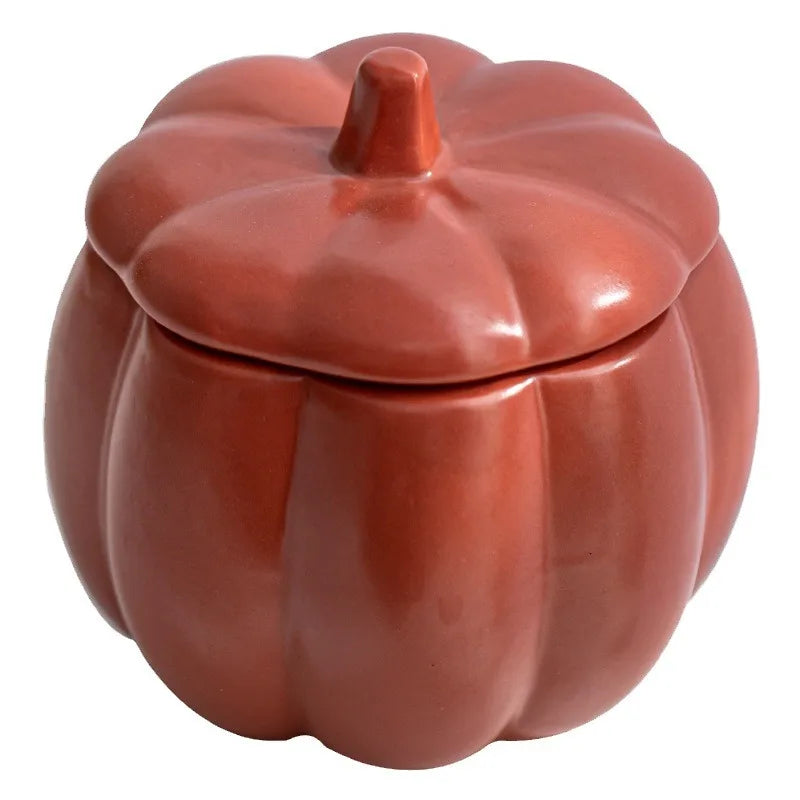 Ceramic pumpkin-shaped container on a white background. fall home decor
