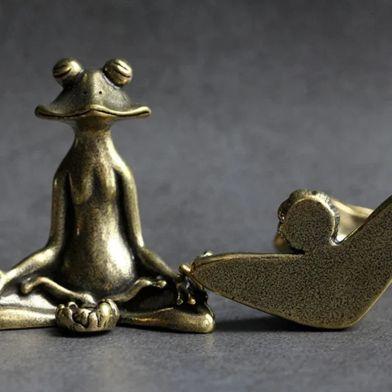 Bronze sculpture of a dog and a bird on a dark gray background