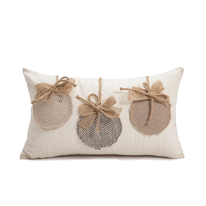 Decorative pillow with three textured ornaments on a white background