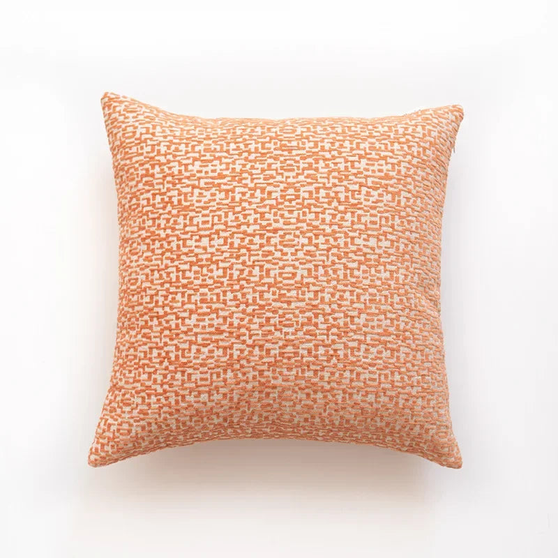 Orange patterned pillow on a white background