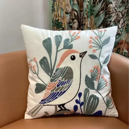 Decorative pillow with a bird design on a brown couch Embroidered flower pillow cover, 17.7-inch square canvas cushion case with floral design for sofa, bed, and boho home decor