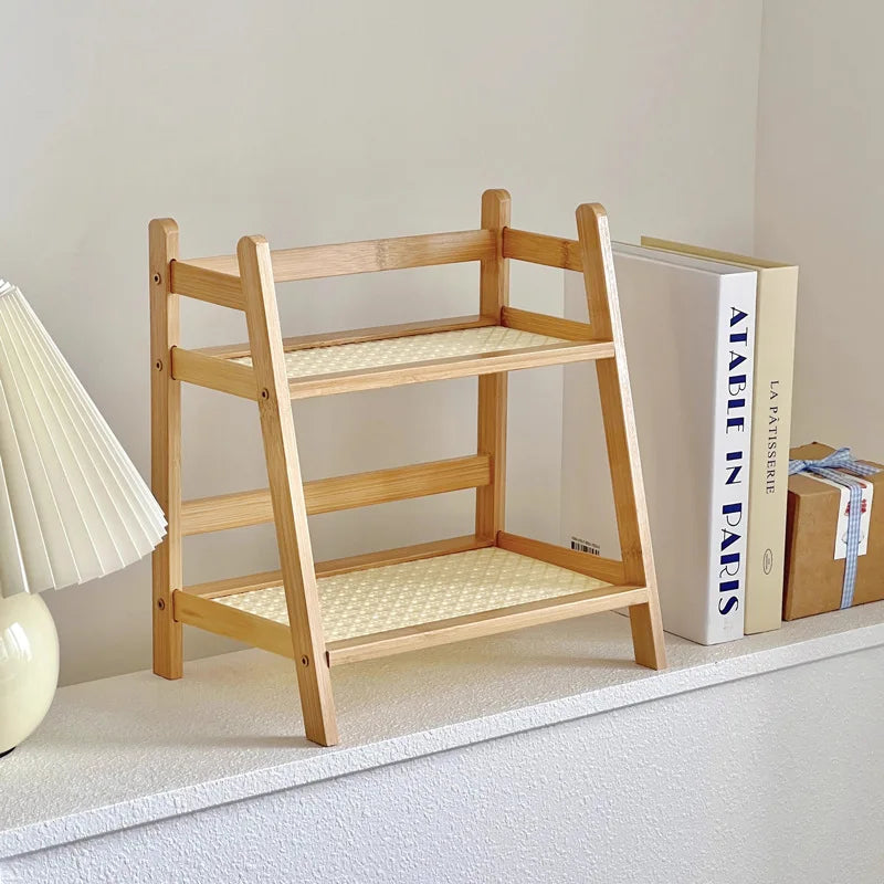Wooden shelf with woven seat and backrest on a light gray floor. 2-tier bamboo countertop organizer shelf in walnut and blonde finish, multipurpose coffee cup holder and storage rack for kitchen, bathroom, or vanity