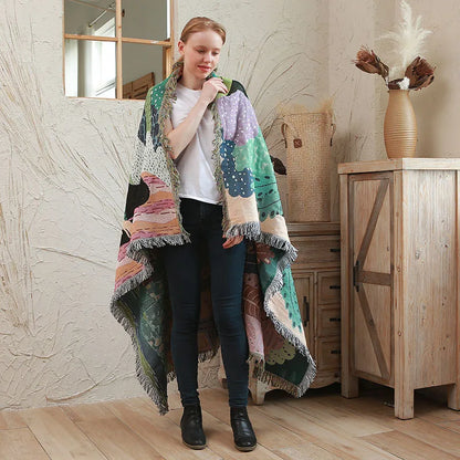 Woman wearing a colorful knitted shawl in a home setting. Boho Home Decor. 