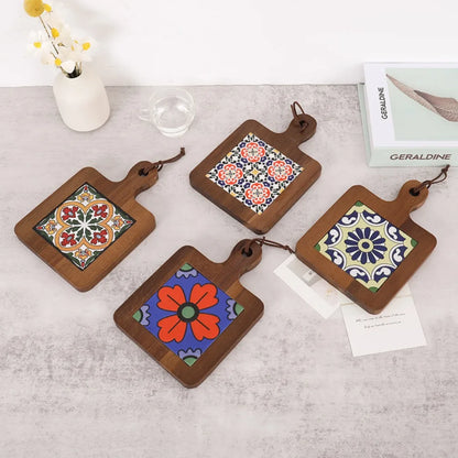 Set of four wooden coasters with colorful tile designs on a light surface.
