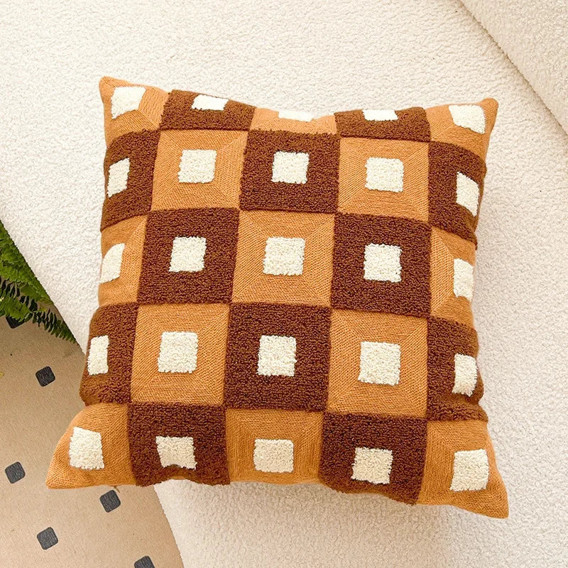 Decorative pillow with a checkered pattern in brown, orange, and white on a neutral background. Bohemian embroidered throw pillow cover 18x18 inch with geometric towel embroidery, decorative cushion for sofa, bed, or living room boho home decor