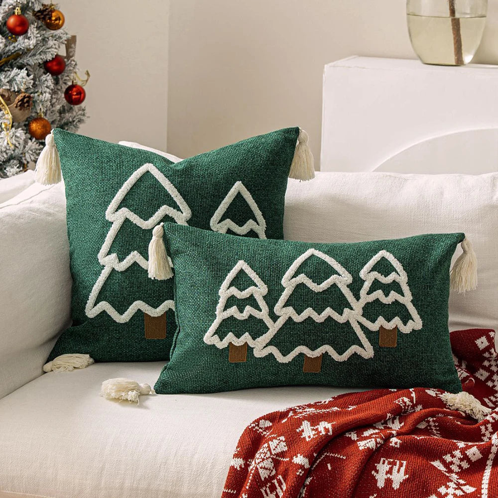 Green pillows with tree patterns on a white couch next to a Christmas tree. tufted Christmas pillow cover with tassels, decorative festive cushion case for sofa or bed in 12x20 or 18x18 inches.