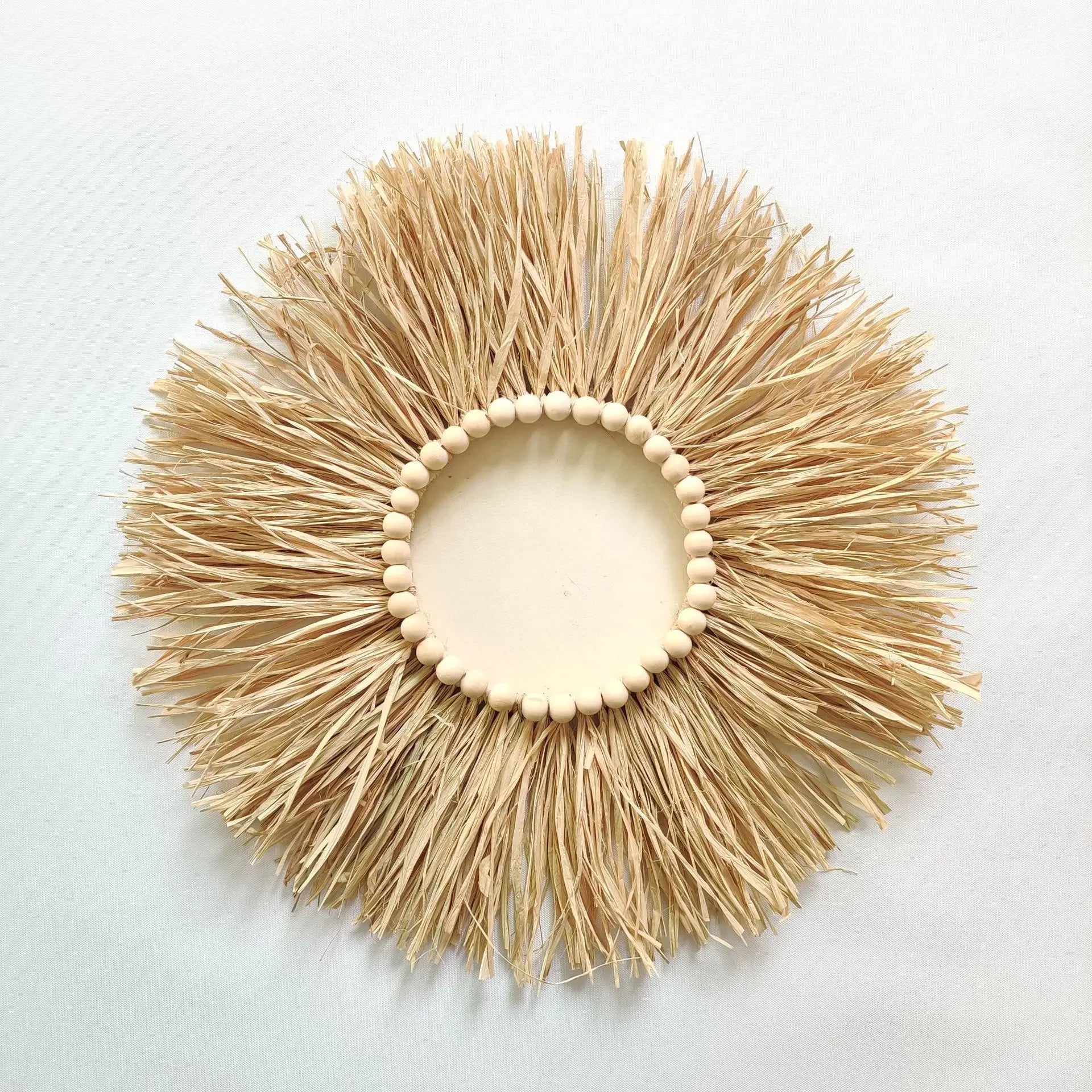 Decorative sunburst wall art with natural straw-like material and wooden beads on a white background boho home decor, boho wall mirror, macrame wall mirror, nordic decor, romantic wedding wall decoration, housewarming gift, round straw mirror, woven wall decor, tapestry mirror, boho bedroom wall accent, rustic mirror wall hanging