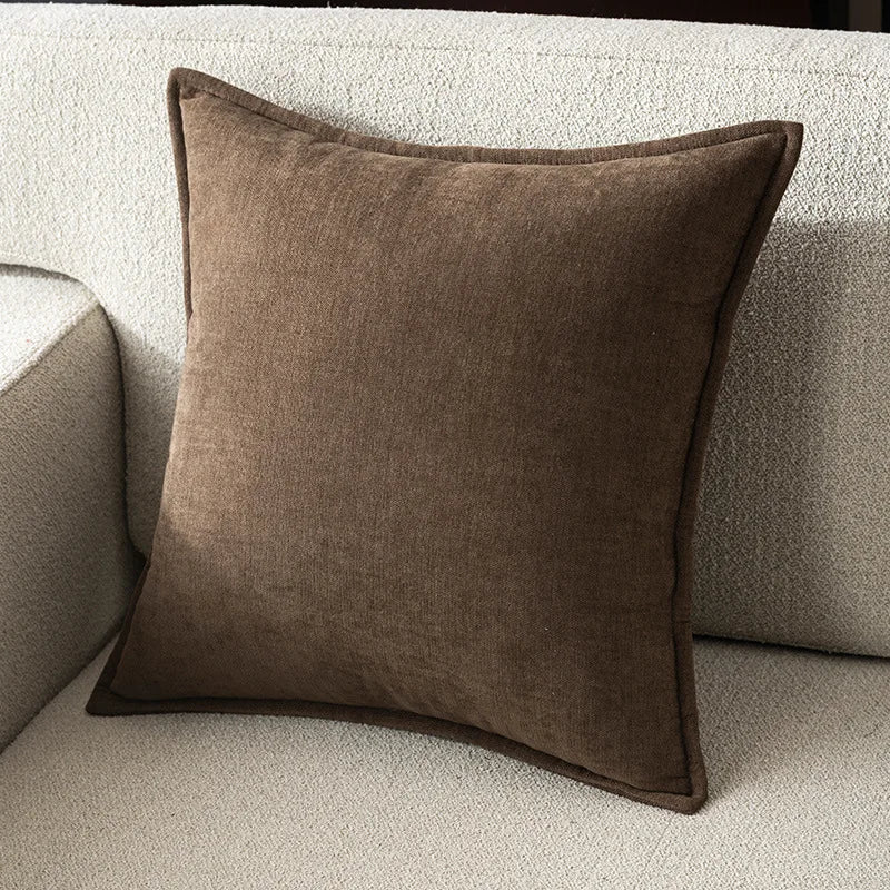 Brown pillow on a beige sofa