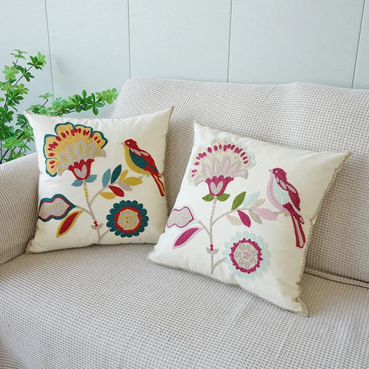 Decorative pillows with floral and bird patterns on a couch. Floral embroidered throw pillow cover boho decor
