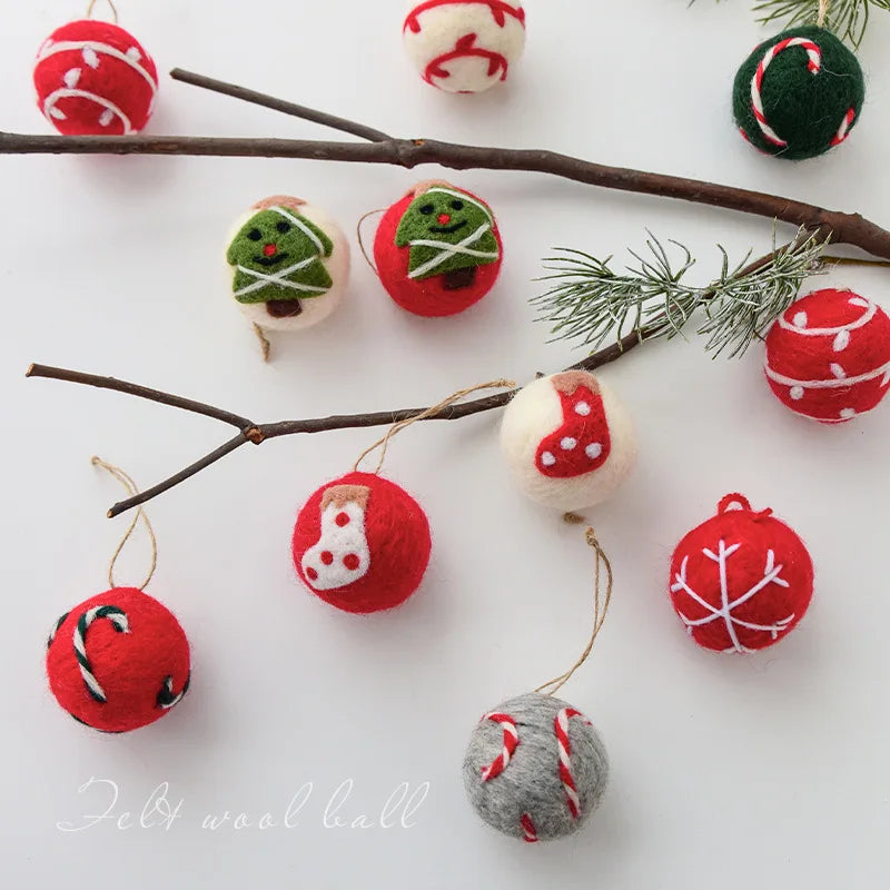 Felt wool Christmas ornaments on a white background with branches and pine needles.