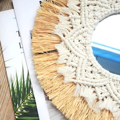 Round woven mat with natural and white fringes on a surface with a magazine. boho home decor, boho wall mirror, macrame wall mirror, nordic decor, romantic wedding wall decoration, housewarming gift, round straw mirror, woven wall decor, tapestry mirror, boho bedroom wall accent, rustic mirror wall hanging